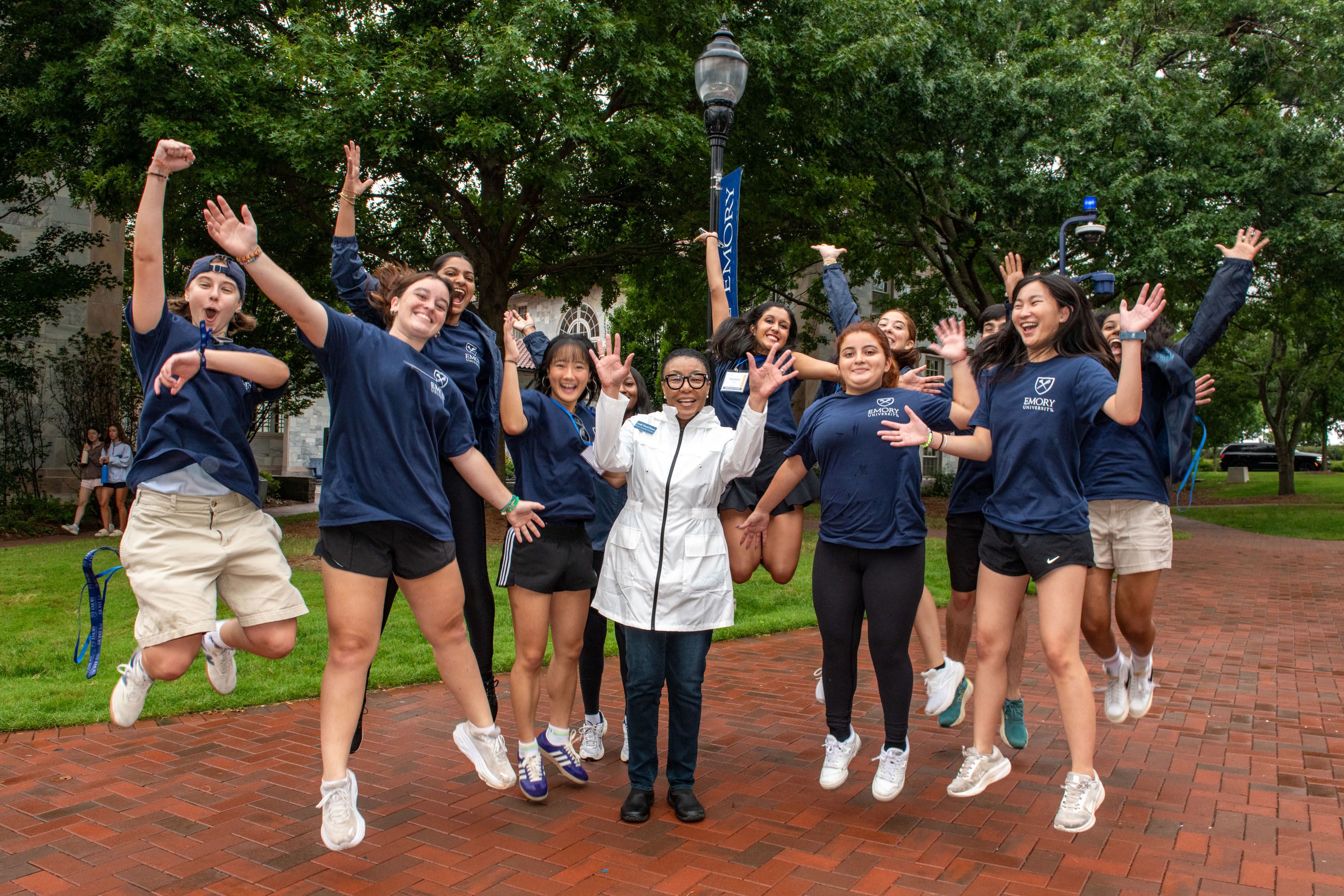 Student in Emory teachers surround Leah Ward Sears as they jump and cheer to celebrate move-in day.