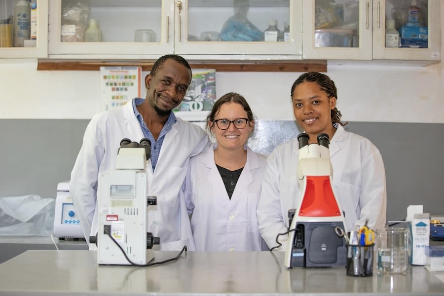 Jessica Deere in the Gombe lab with Dismas Mwacha, veterinarian and project manager at Gombe, and Priscilla Shao, laboratory technician.