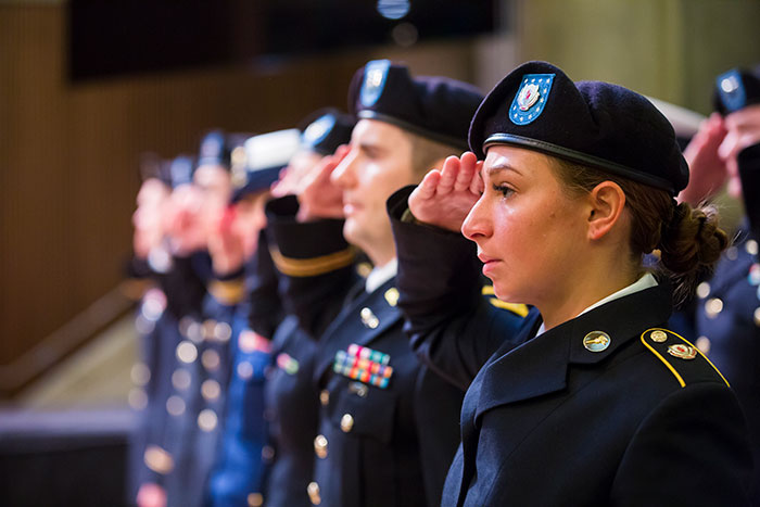 A group of service members salute the flag at the Veterans Day Ceremony