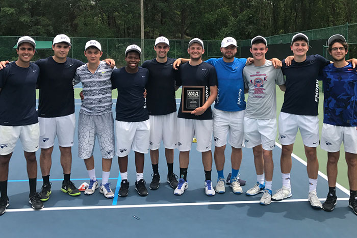 The Emory men's tennis team poses together after claiming its third consecutive UAA title.