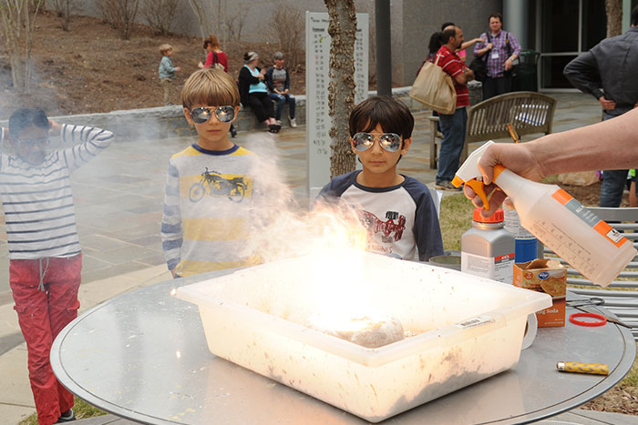 Two children watch a demonstration at the 2017 Atlanta Science Festival.