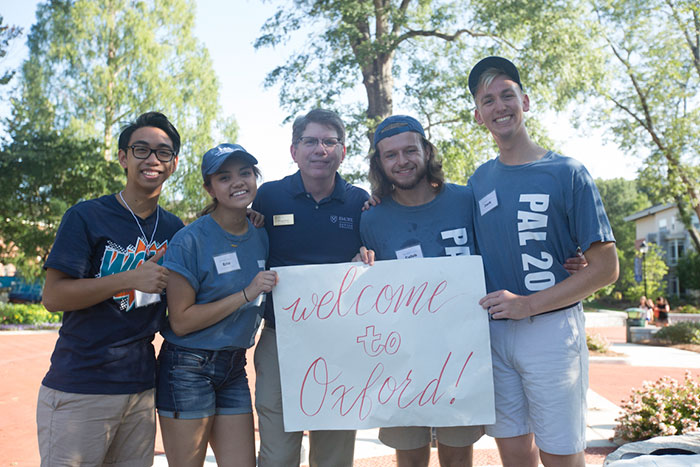 Dean Douglas Hicks poses with student volunteers on Move-In Day.