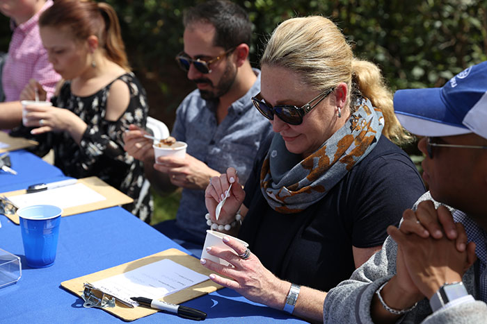 People sample chili at the Greeks Go Green vegetarian chili cook-off.