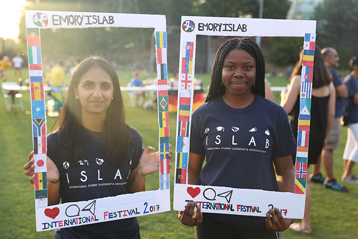 Students pose with signs at the ISLAB International Festival.
