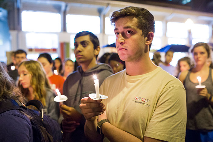 Dozens of Emory students and community members gather with candles at the Oct. 4 candlelight vigil.