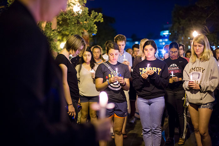 Dozens of Emory community members bow their heads at the Oct. 4 candlelight vigil.