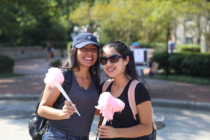 Two students pose with cotton candy they received at the event.