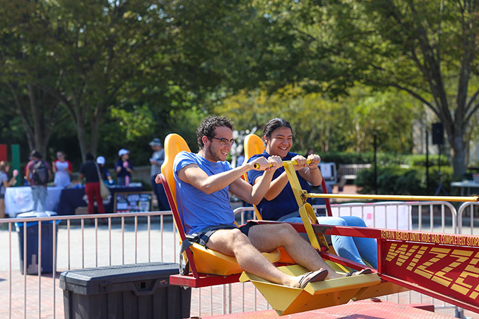Two students ride the "Wizzer" ride.