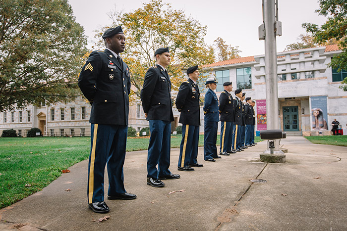 Military members stand "at ease" at the flag pole at the 2017 Veterans Day Ceremony.