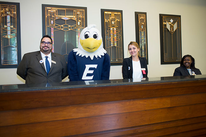 Hotel staff pose with Swoop at the unveiling of the new Swoop statue at the Emory Conference Center Hotel.