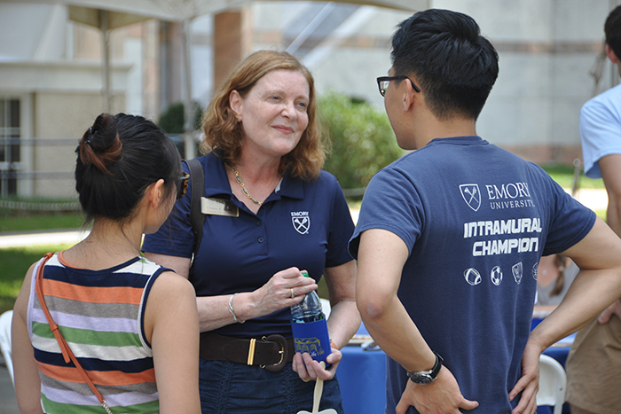 Emory President Claire Sterk with students at Homecoming