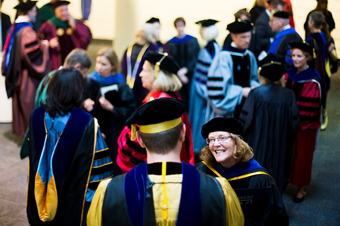Emory President Claire Sterk greeting faculty at Convocation