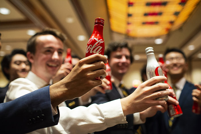 Emory students hold up bottles of Coke for the Class of 2018 toast