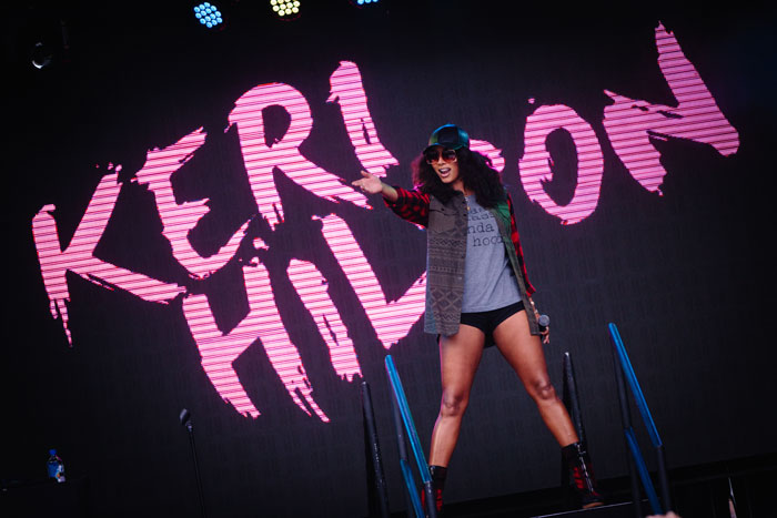 Singer Keri Hilton stands on the Emory stage with a backdrop that says her name