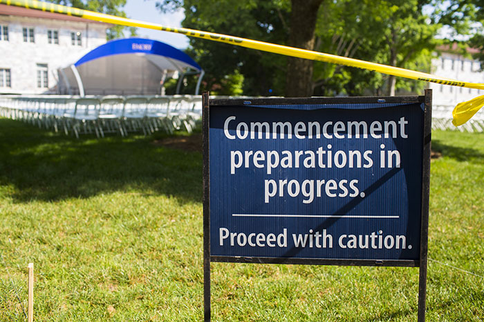 A sign on the quad reads "Commencement preparations in progress. Proceed with caution."