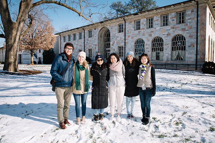 Students pose for pictures in the snow