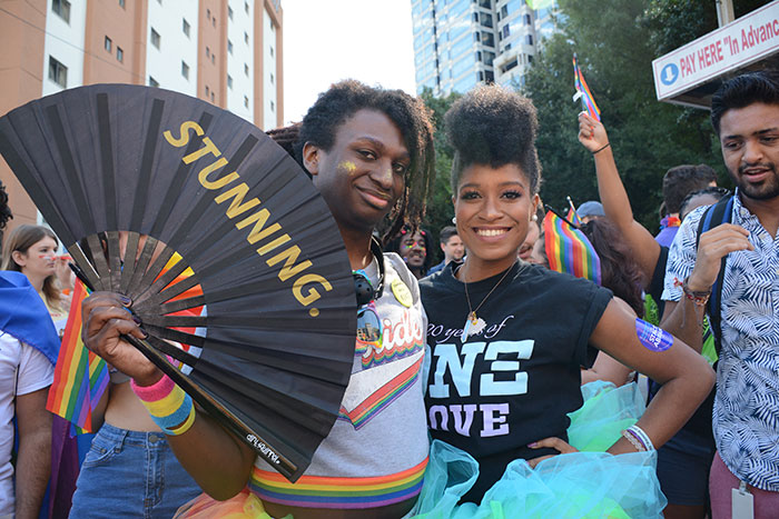 Two Emory students pose with a fan that reads: stunning