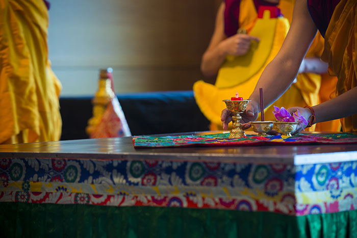 A monk works in a mandala sand painting