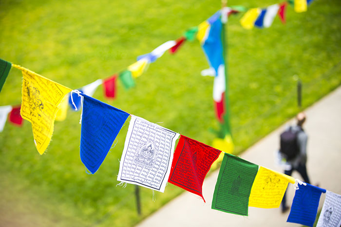 A multi-flag banner is strung across the Emory quad for Tibet Week