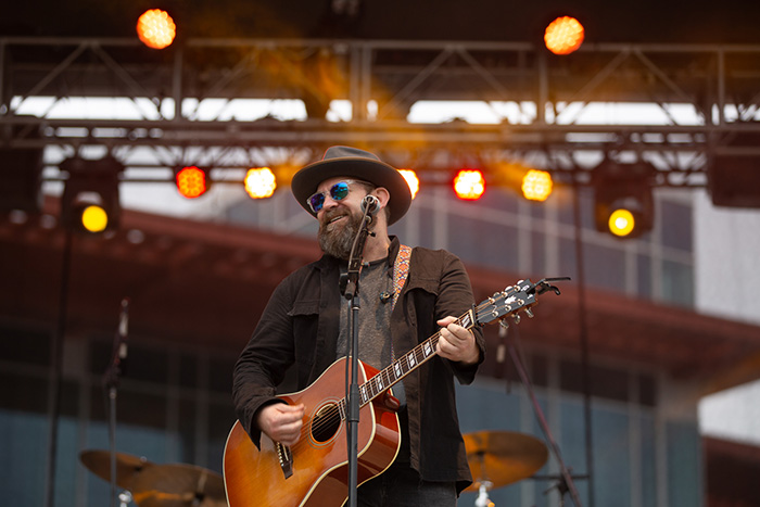 Kristian Bush sings and plays guitar on a stage