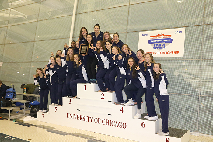 The Emory Women's Swimming and Diving team stands on a podium
