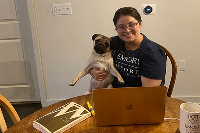 A student poses with her laptop