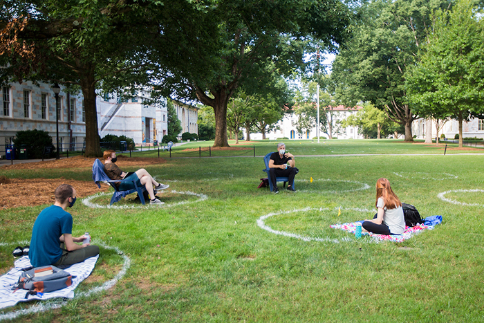 Students sit in socially distanced circles on quad