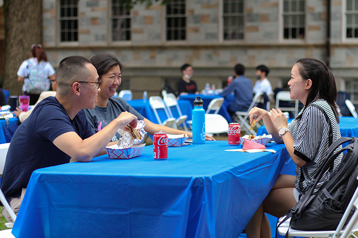 First generation Emory students sit at tables on the Quad
