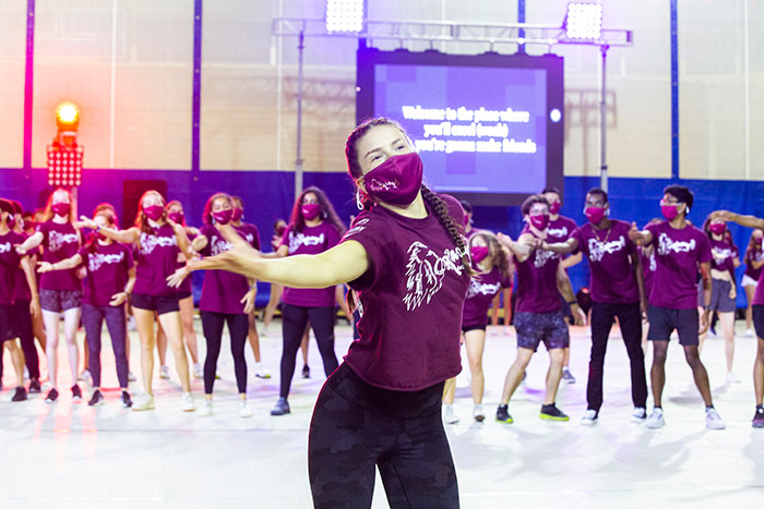 Students from Raoul Hall wear maroon t-shirts and perform at Songfest