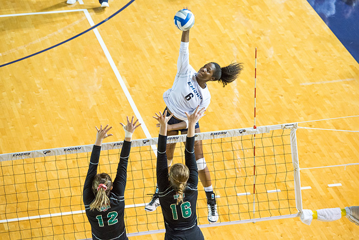 An Emory volleyball player leaps for the ball during a game