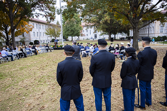 Dozens of members of the Emory community gather on the Quadrangle to listen to a speaker honor veterans
