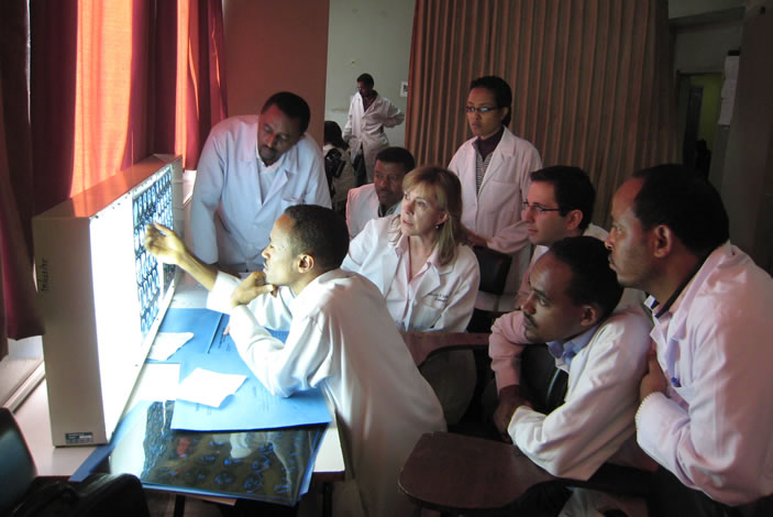 Radiologist Patricia Hudgins reviews a head CT scan with her Ethiopian colleages.