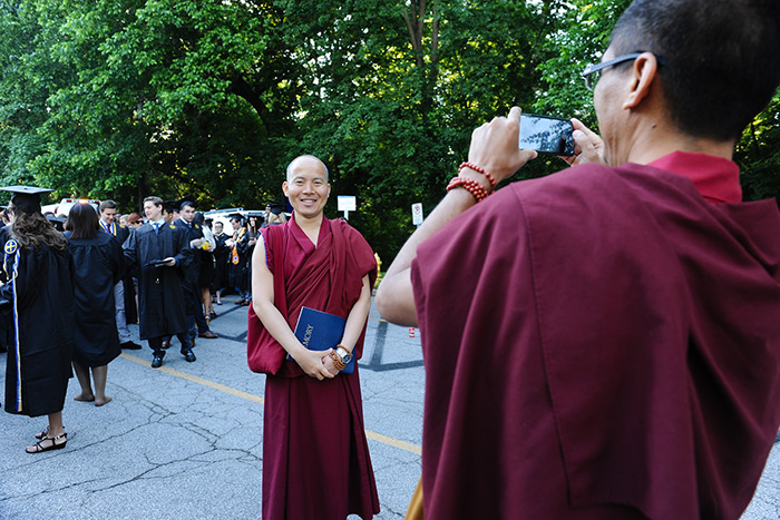A Tibetan monk takes a photograph.