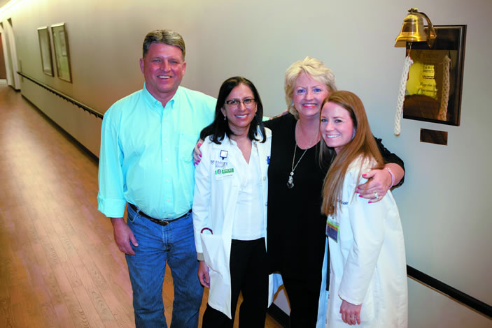 Cathy McCoy with husband Joe, her doctor Ragini Kudchadkar, and research coordinator Cabell Eysmans.