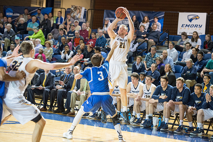 emory player shooting basketball with crowd in background