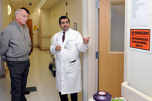 Dr. Aneesh Mehta explains to Gen. John F. Kelly the Emory Hospital special isolation unit's methods for disposing of contaminated materials.