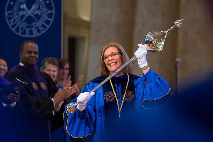 As Sterk received the university mace, attendees rose in a standing ovation to welcome Emory's new president.