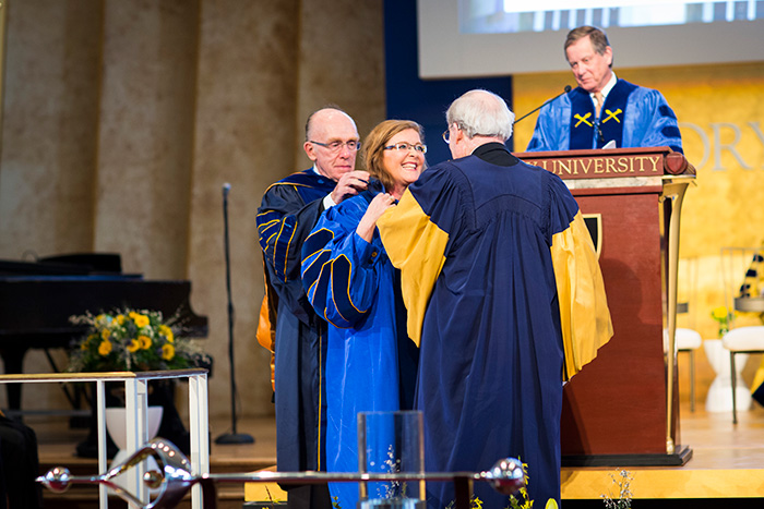 Emory presidents emeritus James T. Laney and William Chace presented Sterk with the gown of office.