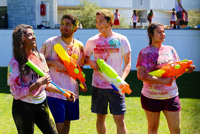 four students with water guns 