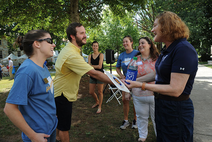 Emory President Claire E. Sterk greets Homecoming attendees