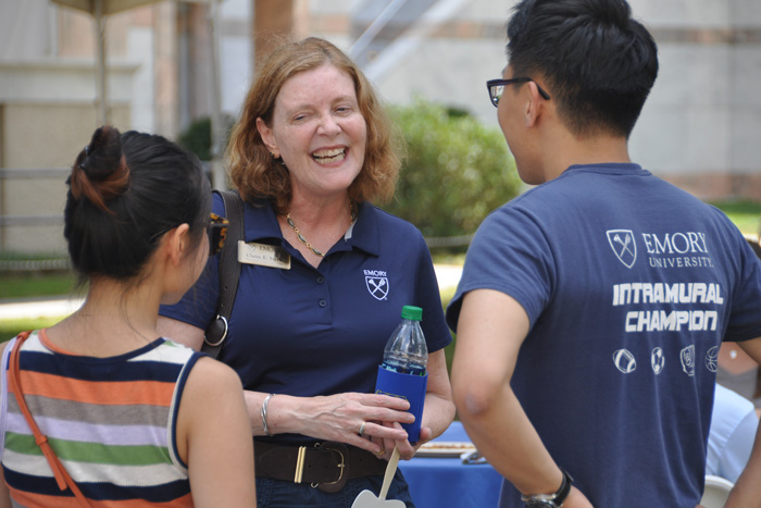 Emory President Claire E. Sterk visits with students during Homecoming