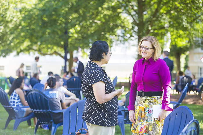 Emory President Claire E. Sterk speaks with an Emory community member