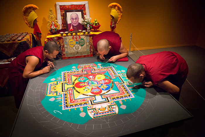 monks working mandala from above