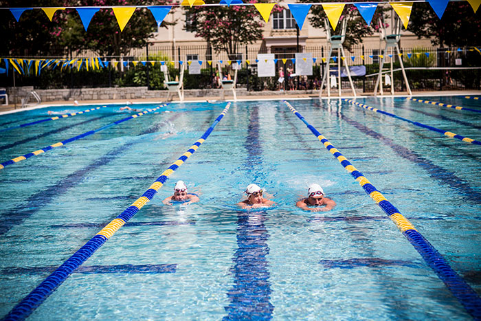 three swimmers in pool