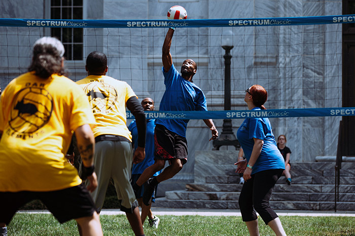 Staff members play volleyball at Staff Fest
