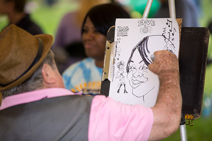 A staff member gets her caricature drawn
