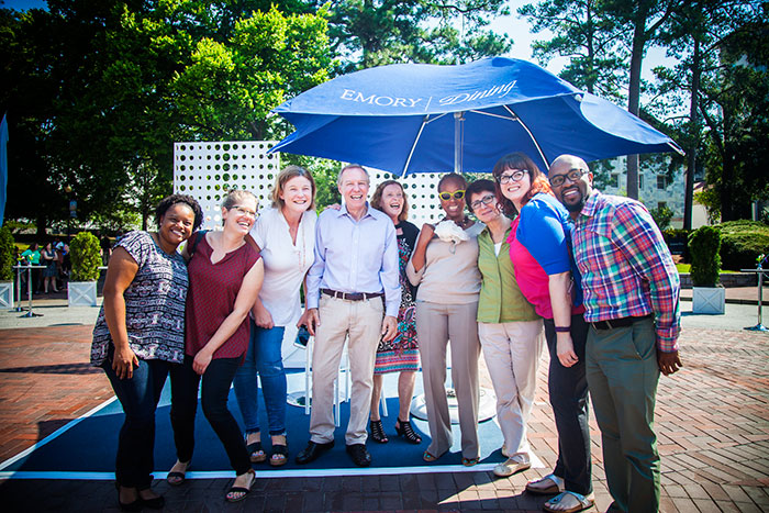 Emory President Claire E. Sterk poses with well-wishers at the welcome block party.