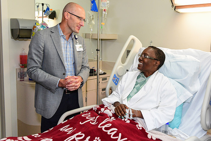 Emory University Hospital CEO Bryce Gartland, MD, visits with Crystal McCollum in her room before she is moved to the new Emory University Hospital Tower.