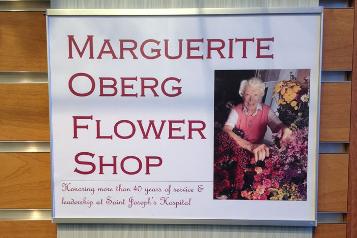 A special plaque notating 'The Marguerite Oberg Flower Shop' hangs at the entrance of the shop.