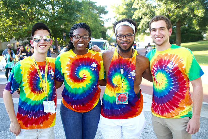 Four students posing in tie-dyed t-shirts at Camp Swoop.